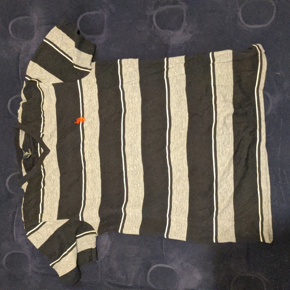 Small black, white, and grey varying striped polo v-neck short sleeve shirt.